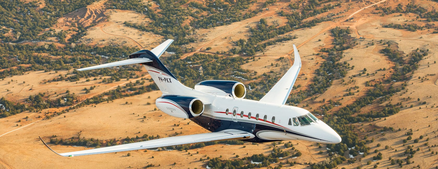 Cessna Citation X flying over the savana