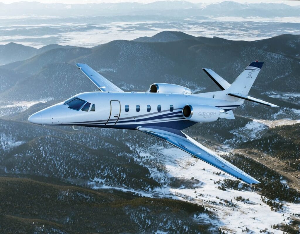 Cessna Citation XLS flying over snowy mountains