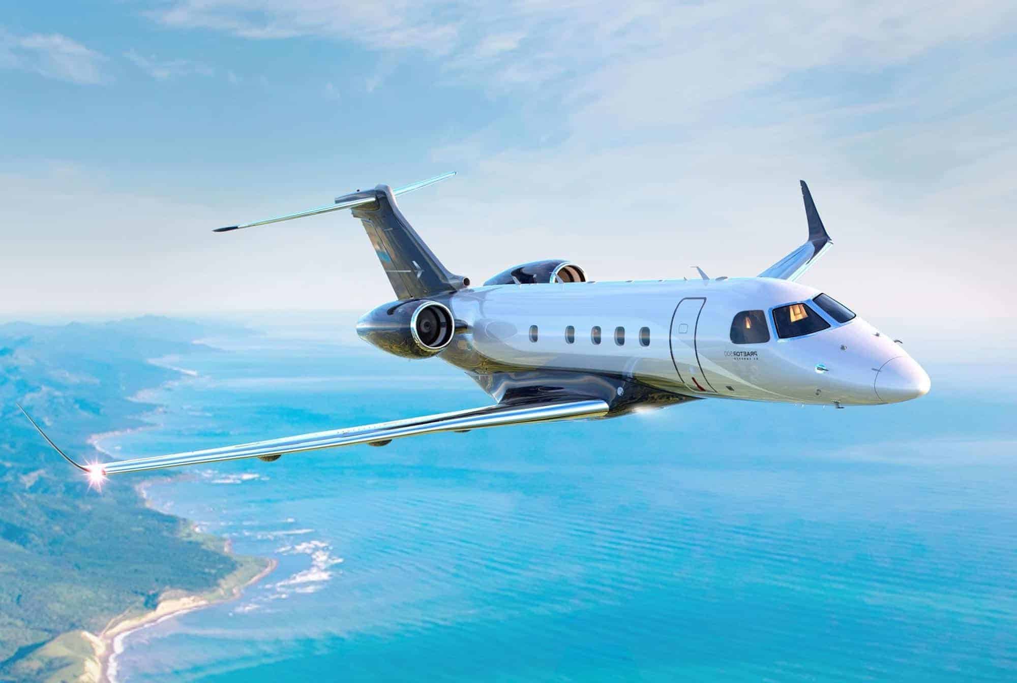 Embraer Praetor 500 flying over the beach ocean