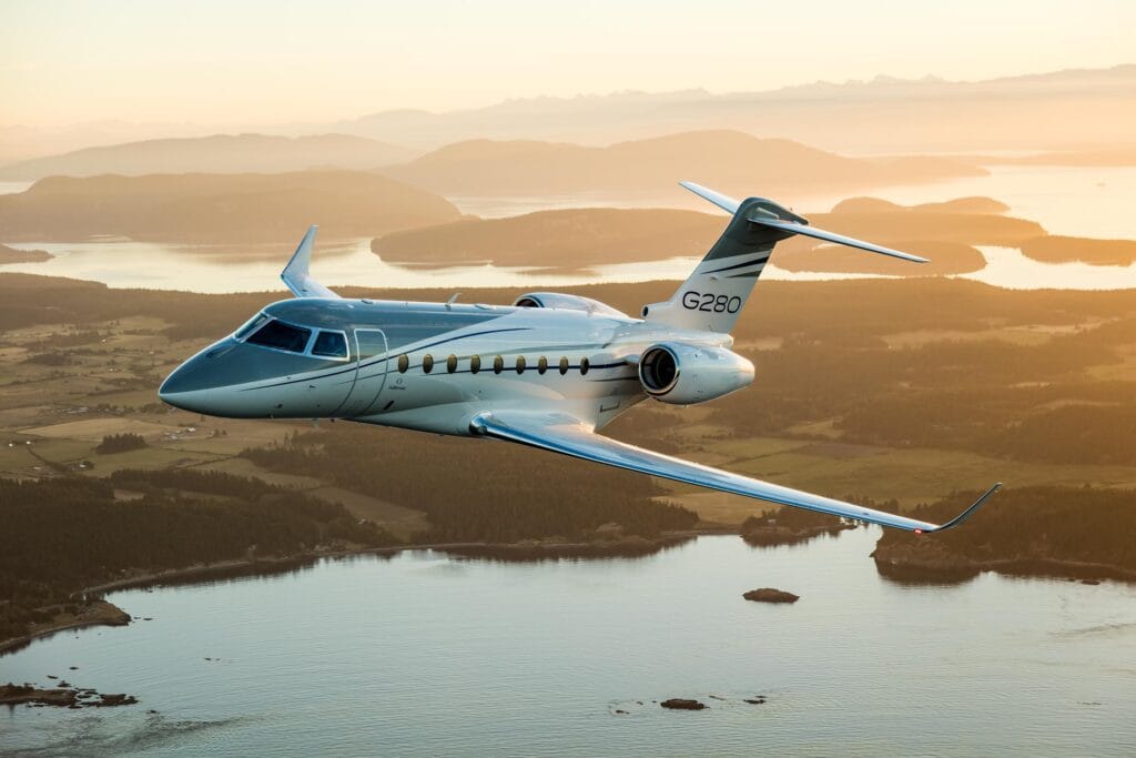 Gulfstream G280 flying with sunset in the background